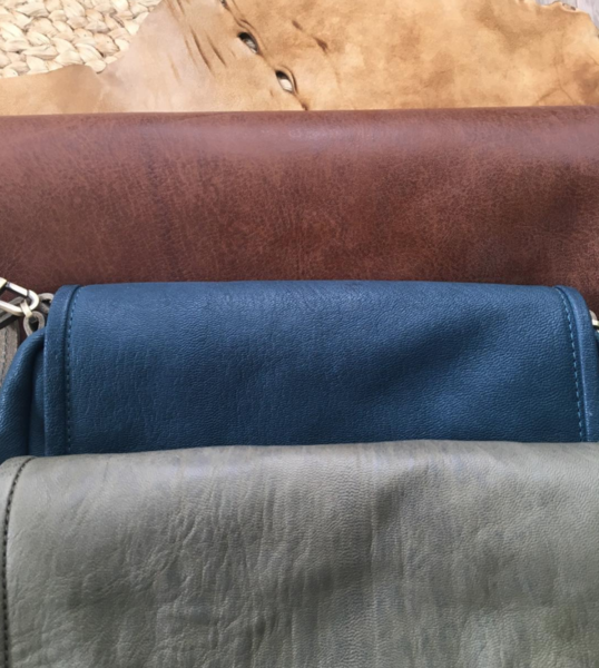 crossboy bag in three different colors: brown, blue, and gray